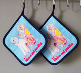 “Bitches and Poodles” pot holder by Katrin Valgemäe displayed in a kitchen setting, blending functionality with artistic flair