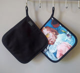 Both sides of the “Pervert in the Kitchen” pot holder, displaying its artistic design on the front and durable cotton-polyester backing