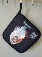 “Carnivore” pot holder by Katrin Valgemäe displayed in a kitchen setting, blending practicality with artistic charm