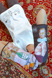 Flatlay view of the “Pervert in the Kitchen” oven glove and matching pot holder, emphasizing the artistic details