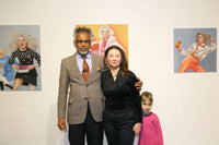 Guests at the “Queens of Chaos” exhibition with “Milk” by Katrin Valgemäe displayed in the background, highlighting its thematic presence
