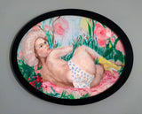 “Once in the 80s” by Katrin Valgemäe, displayed in an elegant black frame, emphasizing its unique oval shape
